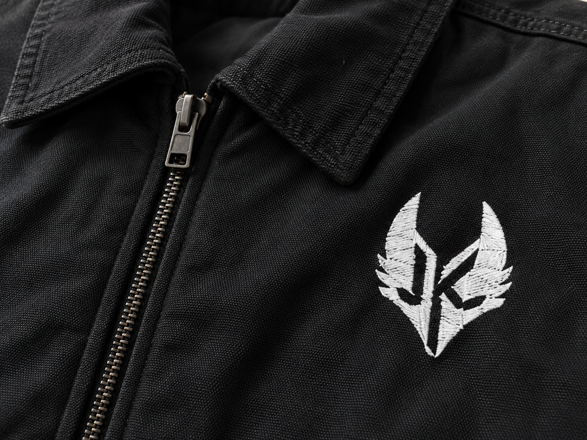 Close-up of metal zipper and KENFEEZZ emblem on dark fabric